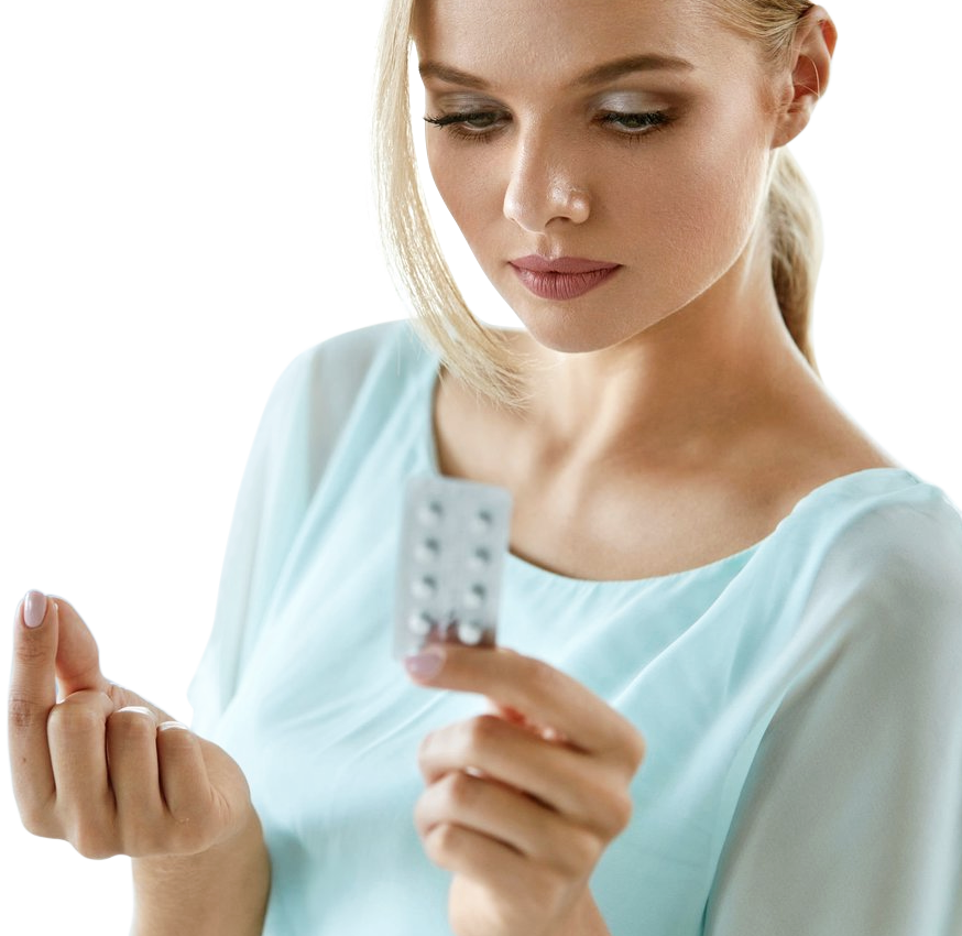 A woman looking at her blister pack of contraceptive pills as she holds one pill between her thumb and forefinger