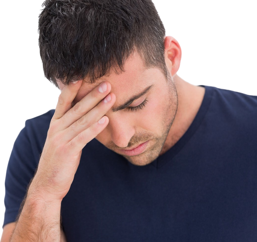 A man in a navy blue t-shirt holding his head in one hand and looking miserable