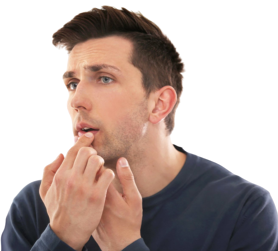 A man holding his hands up to his lips and examining the cold sore on his bottom lip